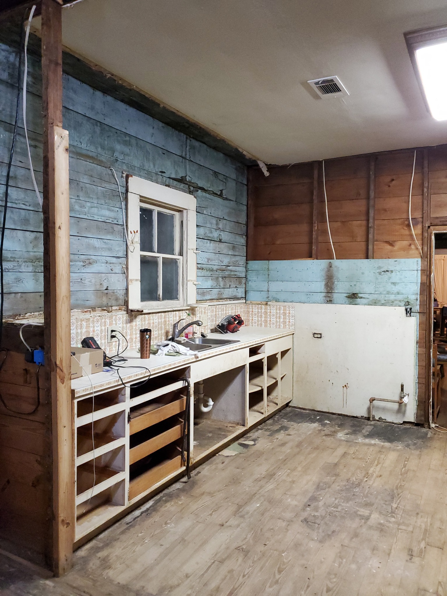 Gutted kitchen with exposed studs — sold as-is no repairs