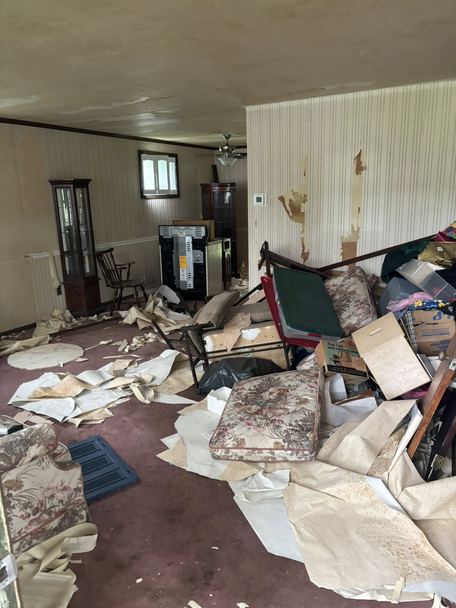 Heavily damaged home interior with debris — bought as-is for cash
